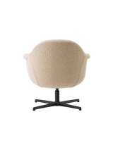 Back view of the Harbour Lounge Chair with light beige textured upholstery and a black, star-shaped swivel base.