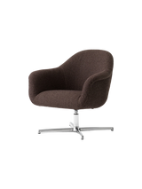 Angled view of the Harbour Lounge Chair upholstered in a dark brown Baena fabric, with a polished aluminium swivel star base.