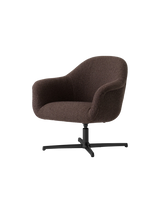 Angled view of the Harbour Lounge Chair, upholstered in dark brown Baena 15 fabric with a black aluminium star swivel base.